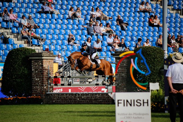 Andrew Hoy and Vassily de Lassos over the penultimate fence.