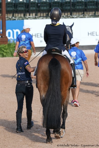 Emma Booth's coach, Lone, has a laugh with her as they enter the arena - © Michelle Terlato